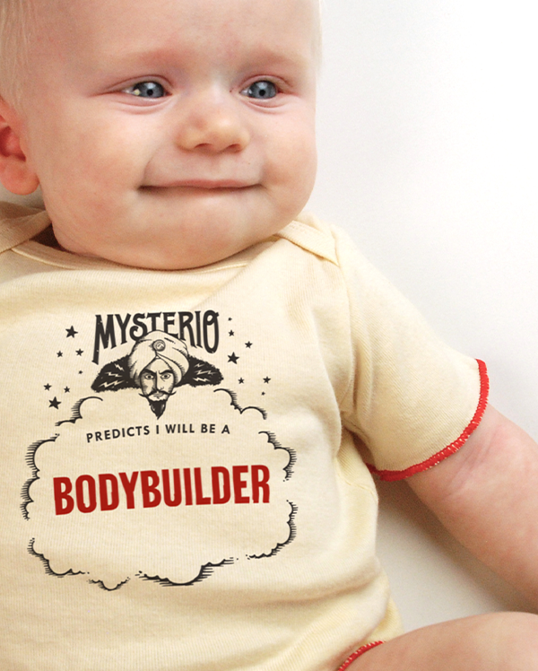 A baby wearing wrybaby's funny fortune teller t-shirt that says 'Mysterio Predicts I will be a Bodybuilder'
