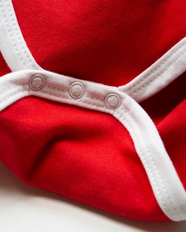 Detail of wrybaby's funny 'RBF (Resting Baby Face)' onesie showing the baby bodysuit's white cotton leg trim.