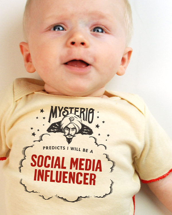 A baby wearing wrybaby's funny fortune teller t-shirt that says 'Mysterio Predicts I will be a Social Media Influencer'