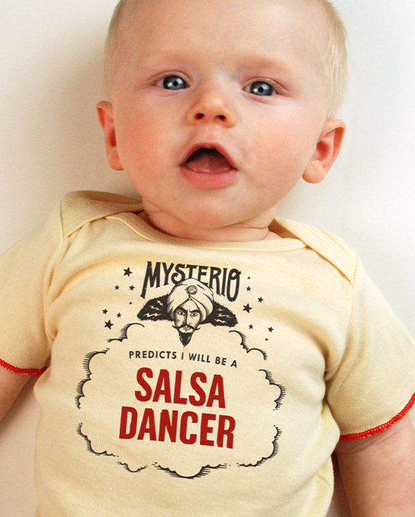 A baby wearing wrybaby's funny fortune teller t-shirt that says 'Mysterio Predicts I will be a Salsa Dancer'