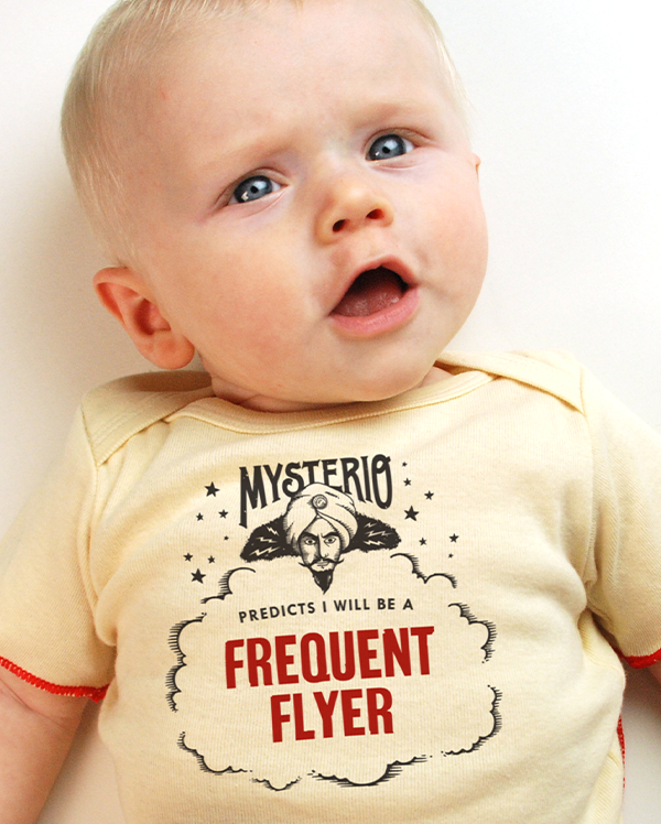 A baby wearing wrybaby's funny fortune teller t-shirt that says 'Mysterio Predicts I will be a Frequent Flyer'