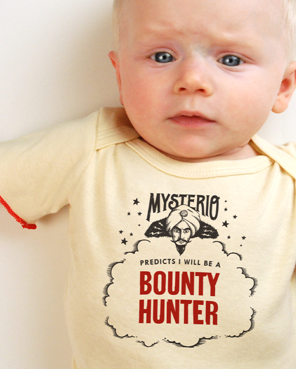 A baby wearing wrybaby's funny fortune teller t-shirt that says 'Mysterio Predicts I will be a Bounty Hunter'