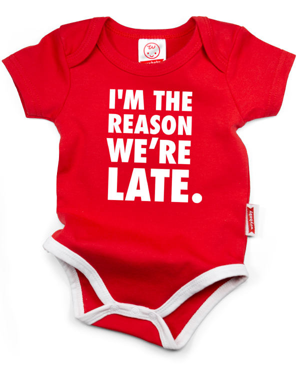 A red cotton funny onesie made by wrybaby with 'I'm the Reason We're Late' printed on the front in a nice design