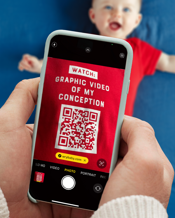 A smart phone scanning the funny qr code onesie by wrybaby