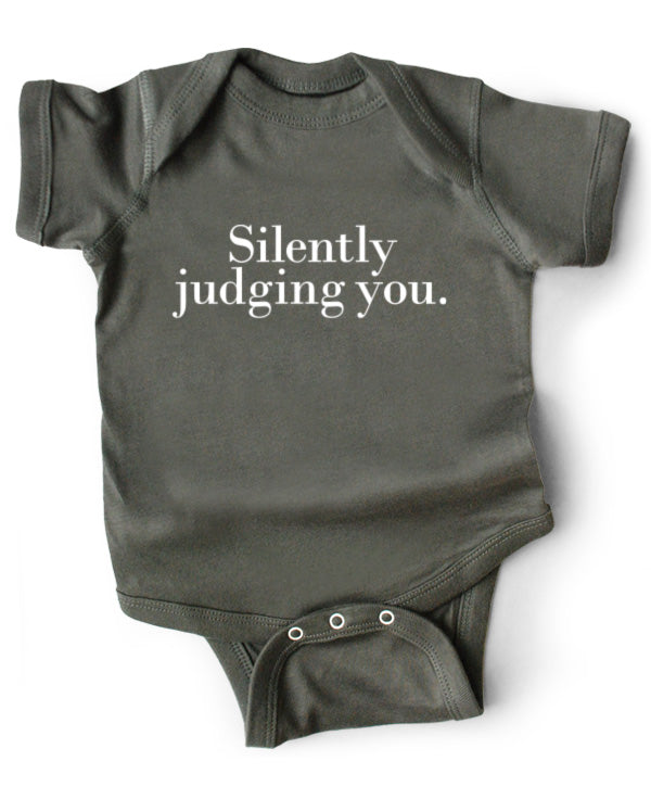 A gray cotton funny onesie made by wrybaby with 'Silently Judging You' printed on the front in a nice design