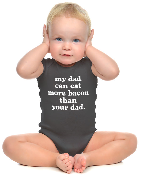 Baby wearing funny onesie saying My Dad Can Eat More Bacon Than Your Dad